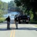 Responders congregate near where two people drowned the evening before when they were locked in a Horry County Sheriff's department transport van in Marion County, S.C. A deputy charged in the deaths ignored barricades and drove into rapidly rising floodwaters against advice from his supervisors and officials on the South Carolina highway, a prosecutor said Monday, May, 16, 2022.