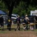 Investigators walk across a school yard at Robb Elementary School in Uvalde, Texas, Wednesday, May 25, 2022.