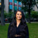 Head shot of Sondra Anton wearing a black dress and standing in Harvard Law School courtyard.
