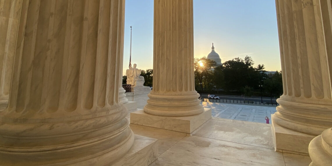 View of U.S. Capitol with sunset from Supreme Court steps