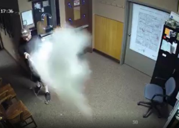 Man discharges fire extinguisher at LEO after cuffs loosened, is shot