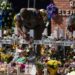 A state trooper places a tiara on a cross honoring Ellie Garcia, one of the victims killed in this week's elementary school shooting in Uvalde, Texas Saturday, May 28, 2022.