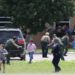 Law enforcement officials evacuate children from Robb Elementary School after a gunman killed 19 students and two teachers on March 24, 2022 in Uvalde, Texas.