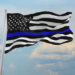 Neighbors fly thin blue line flags after HOA tells slain officer’s father to take his down