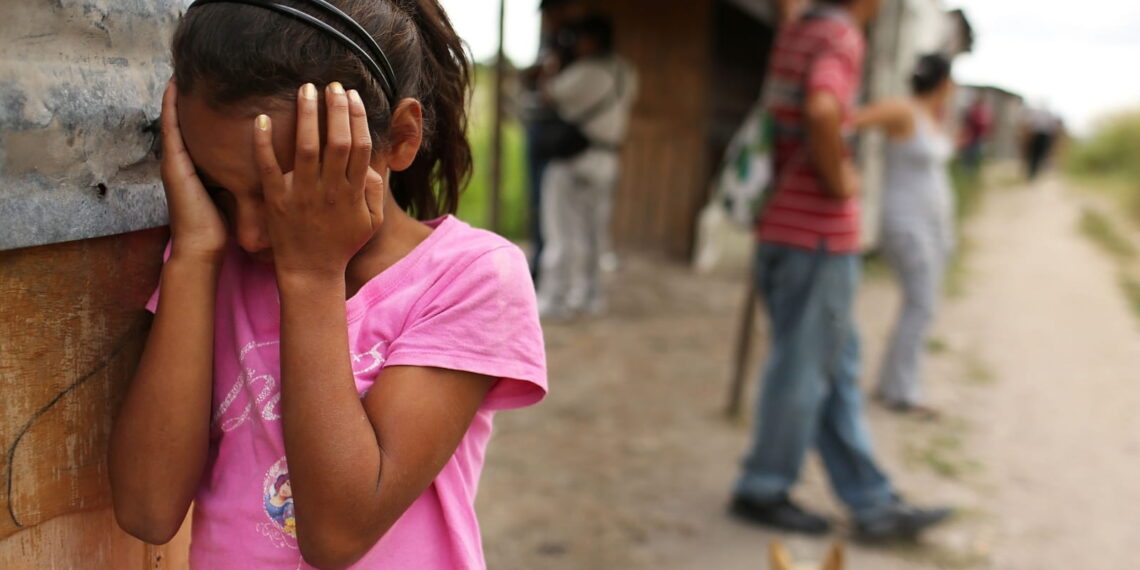 Young girl covering her eyes