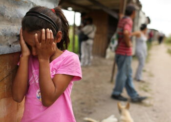 Young girl covering her eyes