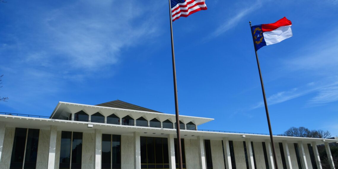 The North Carolina Legislative Building with the North Carolina and U.S. flags flying