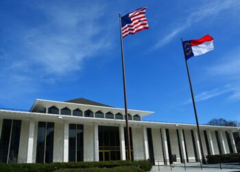 The North Carolina Legislative Building with the North Carolina and U.S. flags flying