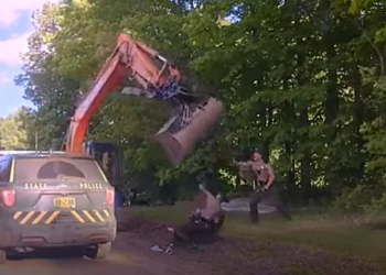 Man swings excavator's shovel bucket at troopers to stop son’s arrest