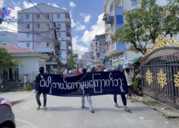 Masked protesters in Yangon.