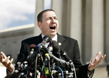 Robert Schenck stands in front of a cluster of microphones at the Supreme Court Building in 2005