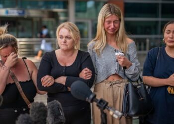 Hollie Dance (second left) surrounded by family and friends, outside the Royal London hospital