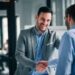 Portrait of cheerful young manager handshake with new employee.