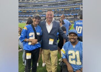 Lt. Randy Sutton, center, the founder of The Wounded Blue, poses with California Highway Patrol officer Juan Reyes, left, and San Bernardino Sheriff's deputy Marcus Mason at SoFi Stadium on Aug. 20, 2022.