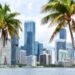 Downtown Miami skyline along waterfront seen through palm tress in South Florida
