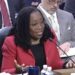 ketanji brown jackson sitting behind microphone with palms turned upward