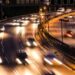 cars driving down the highway at night