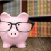 Piggy bank with glasses on in a library
