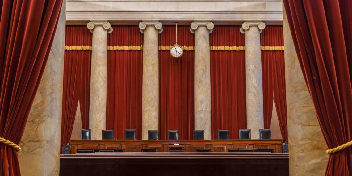 view of empty supreme court bench as seen from back of courtroom