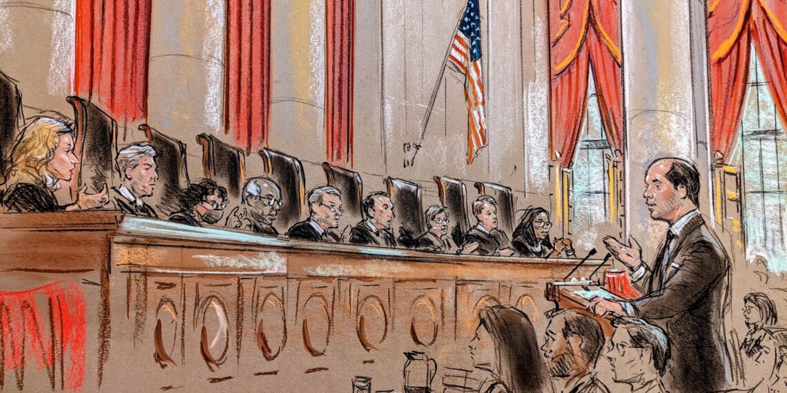 sketch of man gesturing with his right hand before the lectern, speaking before a full bench. Justice Sotomayor shapes her hands as if she were taking a picture.