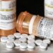 pill bottles bearing an oxycodone label, with pills lying on table