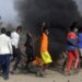 Protestors burning things in a demonstration in the streets of Chad.