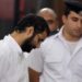 Alaa Abd el-Fattah (left) in court during his trial in Cairo, on 11 November 2014.