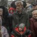 People attend an aid supply distribution in Kherson on Thursday.
