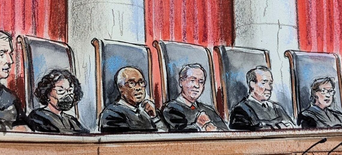 artist's rendition of nine justices in robes sitting behind judicial bench, looking out over an empty lectern. sonia sotomayor wears a mask. large curtains and an american flag hang in the background.