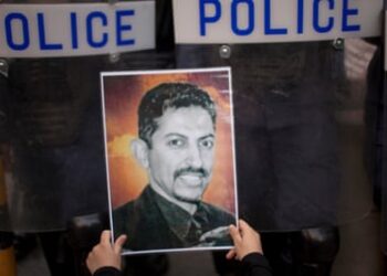 A protester holds a picture of the Bahraini human rights activist Abdulhadi al-Khawaja in Manama