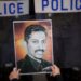 A protester holds a picture of the Bahraini human rights activist Abdulhadi al-Khawaja in Manama