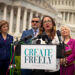 Woman speaking at podium in front of U.S. Capitol building