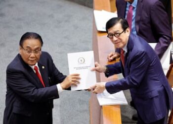 Yasonna Laoly, the Indonesian minister of law and human rights, receives the new criminal code report from Bambang Wuryanto, the head of the parliamentary commission overseeing the revision