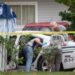 Mississippi Bureau of of Investigations investigators inspected a police vehicle on the scene of the murder of two police officers outside a Motel 6.