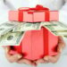 money bonus A red gift box with hundred dollar bills