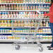 Shopper checking list in supermarket aisle