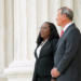 Justice Ketanji Brown Jackson and Chief Justice John Roberts stand on the steps of the Supreme Court Building
