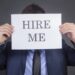 Man Holding “Hire Me!”