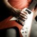 A person playing a rock and roll guitar