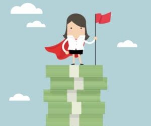 Businesswoman with winners flag standing on money stairs.