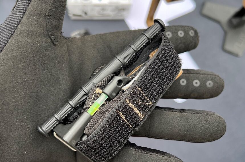 The ETQ (Everyday Carry Tourniquet) Tourniquet from Snakestaff Systems is a keychain-sized TQ with a full-sized textured windlass and a carabiner closure. The yellow item in the photo is an attached chemlight.