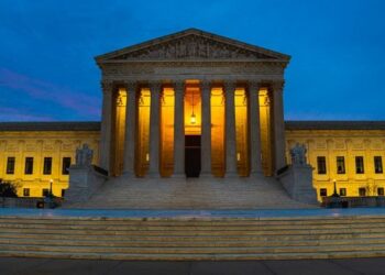 SCOTUS building at night with lights