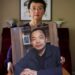 Luo Shengchun, the wife of Ding Jiaxi, poses with a photo of her husband at her home in Alfred, New York, last year