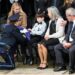 Kansas City Police Chief Stacey Graves, left, presents a flag to Ayden, a son of fallen Kansas City Police Officer James Muhlbauer, 42, during the funeral for Muhlbauer and his police K-9, Champ, Wednesday, Feb. 22, 2023, at Municipal Auditorium in Kansas City. Muhlbauer s family, including his wife, Cassie, left, looks on.