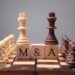 King Chess Pieces With Mergers And Acquisitions Text