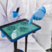 Scientists pointing to embryonic cells on an ipad