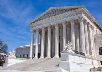 Justices debate propriety of litigation in trial courts while defendants are on appeal seeking arbitration