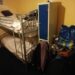 Two bunk beds in a room next to a small cupboard with personal belongings piled up all around it