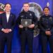 In this photo provided by the Louisville Metro Police Department, from left, Louisville Mayor Craig Greenberg, Officer Nickolas Wilt and Louisville Metro Interim Police Chief Jacquelyn Gwinn-Villaroel pose for a photo, in Louisville, Ky., March 31, 2023. Wilt was shot while responding to a call where a bank employee armed with a rifle opened fire at his workplace early Monday, April 10.