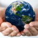 the earth being held by hands